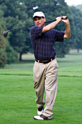 man swinging golf club